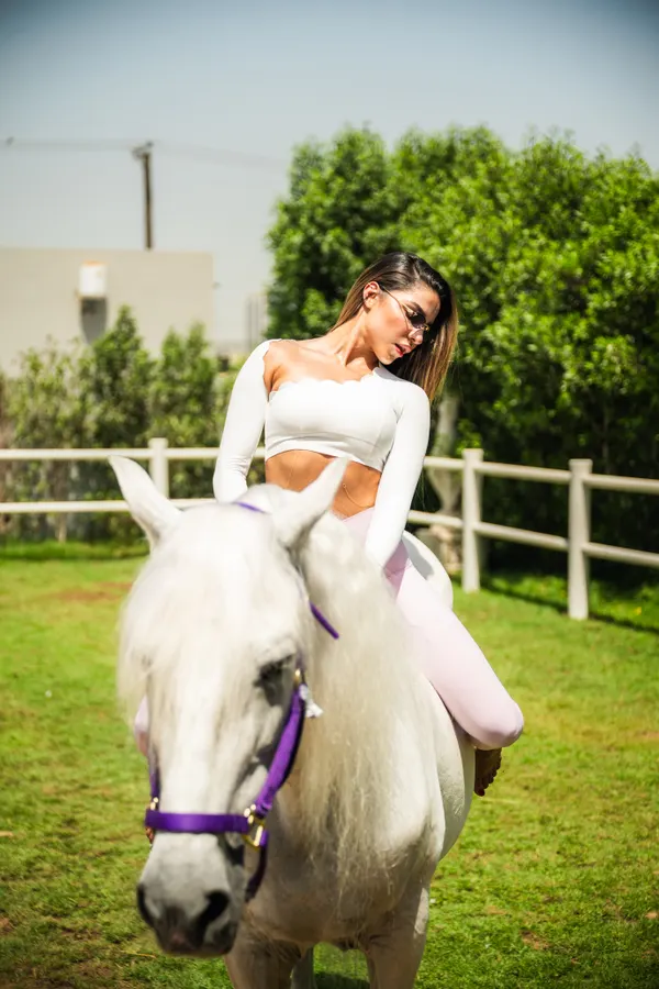 Intimate mounted moment with white horse