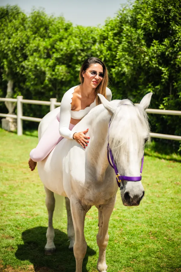 White-outfit portrait with horse at Crystalline Equine