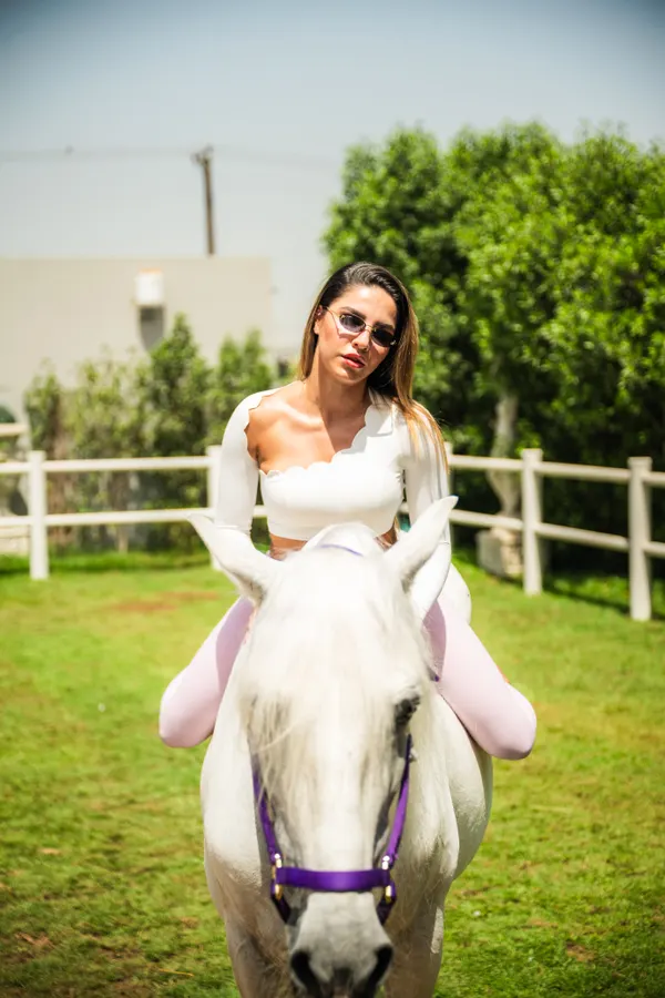 Walking with white horse, hair in motion